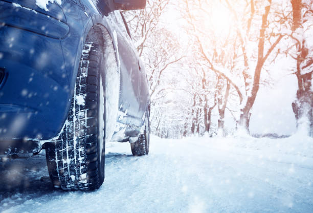 istock Car tires on winter road 601127114