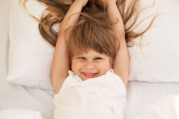 istock Toddler girl laying on bed 601127146