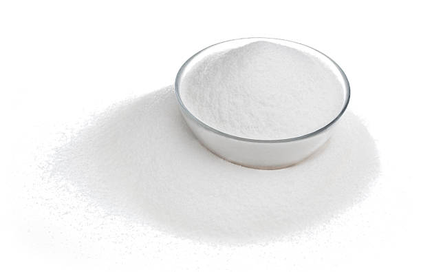 istock Sugar in glass bowl isolated on white 601127274