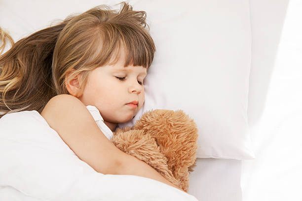 istock Little girl sleep in bed 601127326