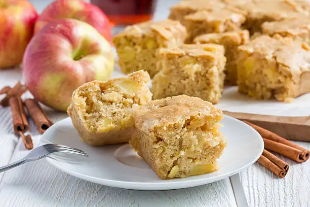 Homemade blondie (blonde) brownies apple cake, square slices on plate, horizontal