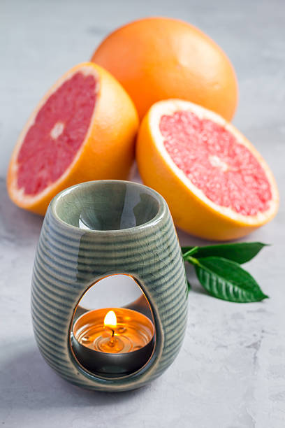 istock Aroma lamp with grapefruit essential oil, grapefruits on background 601129388