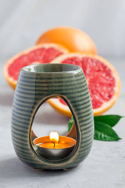 istock Aroma lamp with grapefruit essential oil, grapefruits on background 601129426