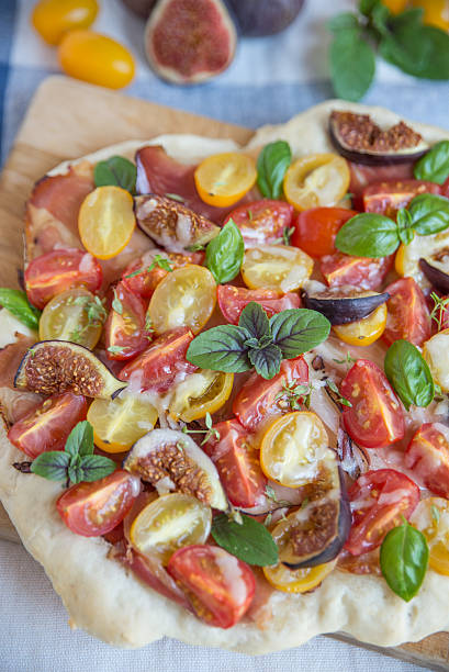 istock Pizza with figs, tomatoes and bacon 601129860