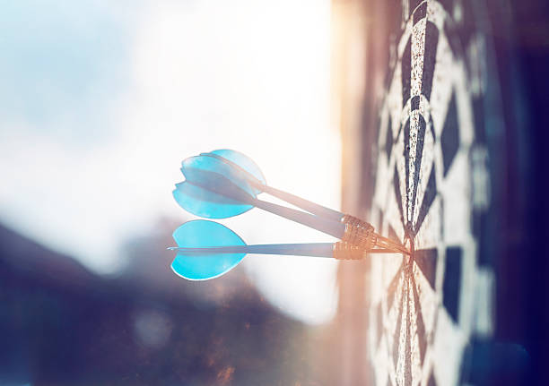 darts board side view of darts boars and arrows in the sunset, outdoor shoot, leisure game background. dartboard photos stock pictures, royalty-free photos & images