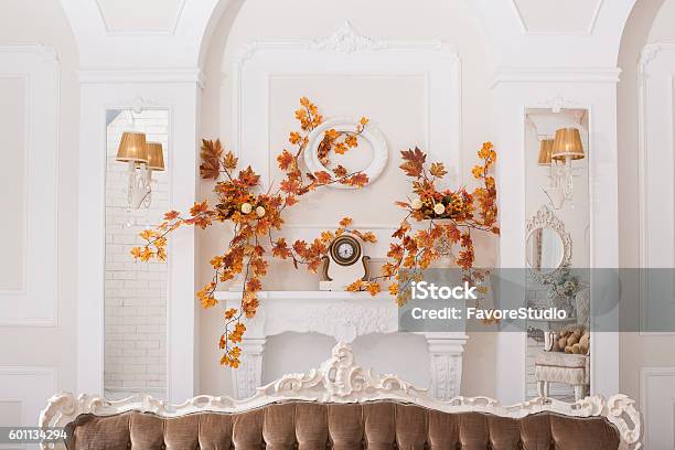 Yellow Leaves Entwined Wall Of White Hall With Fireplace Stock Photo - Download Image Now