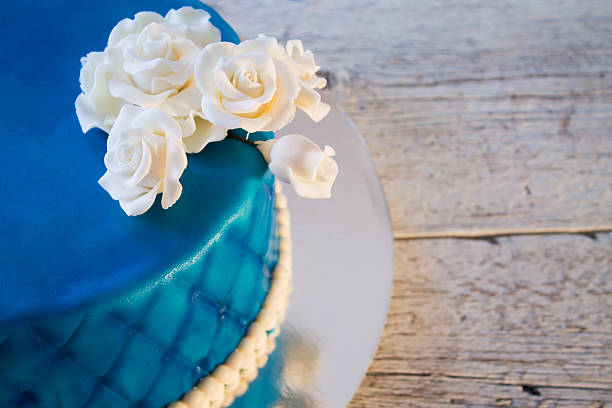 istock blue cake with white roses closeup 601135036