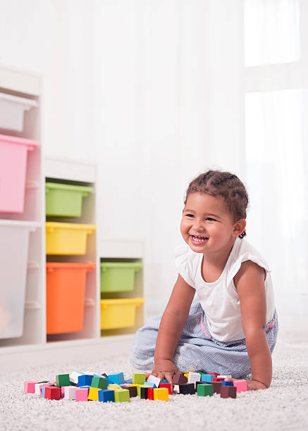 istock Little girl playing with cubes. 601135410