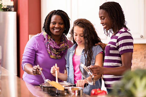 istock Multi-ethnic family at home cooking together in kitchen. 601137262