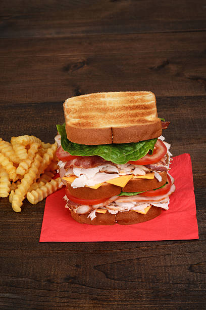 turkey club sandwich on red napkin - club sandwich sandwich french fries turkey imagens e fotografias de stock