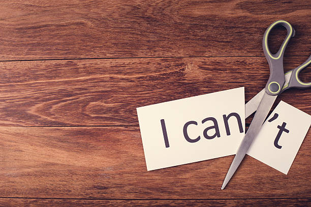 Scissors and word "I can't" on wooden background stock photo