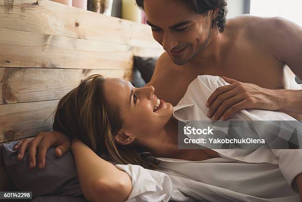 Cheerful Couple Awaking And Looking At Each Other Stock Photo - Download Image Now - Activity, Adult, Affectionate