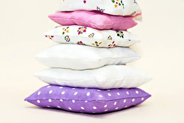 Tower of toy multi-colored pillows.