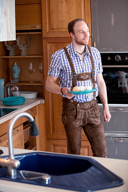 istock man in traditional bavarian clothes standing in kitchen 601144072