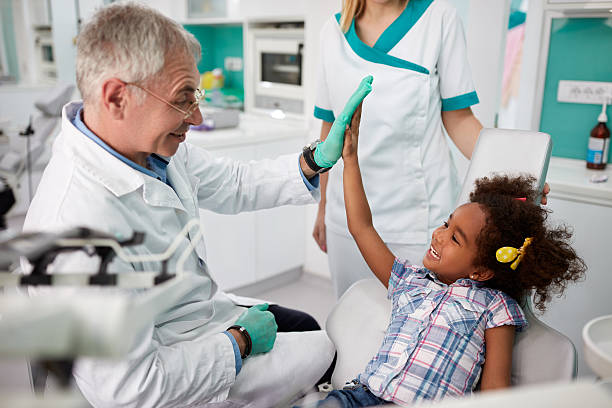 istock Happy kid giving five to dentist 601144120