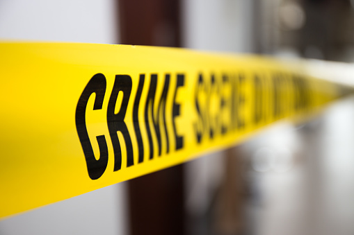 crime scene tape in building with blurred background focus on 'crime '