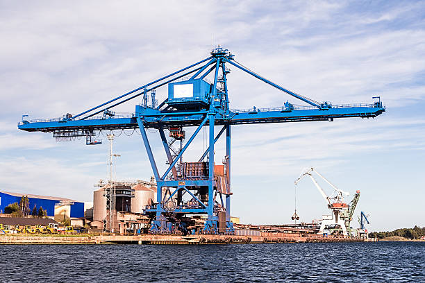 istock Massive blue crane unload cargo in a seaport in Sweden 601145584
