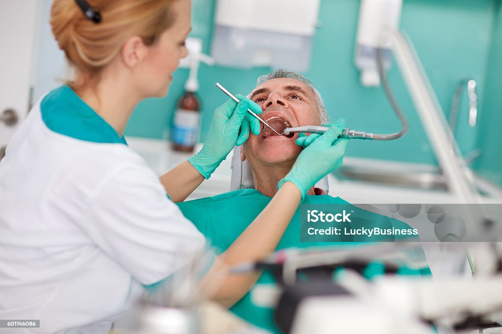 Senior patient repairing tooth Senior patient repairing tooth in dental clinic Adult Stock Photo