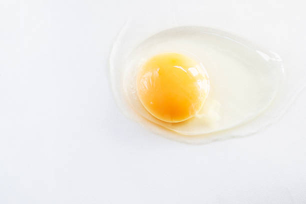 istock white egg is broken and leaked on a white background. 601146114