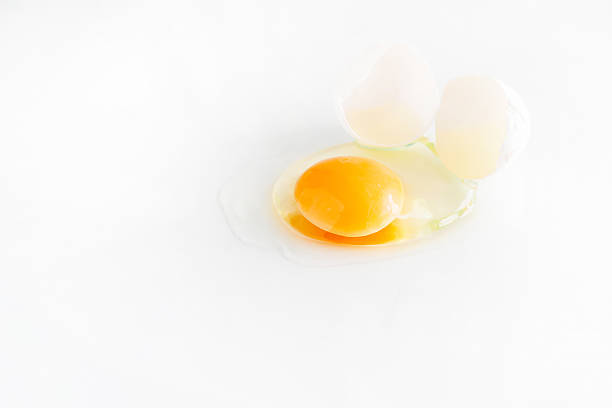 istock white egg is broken and leaked on a white background. 601146130