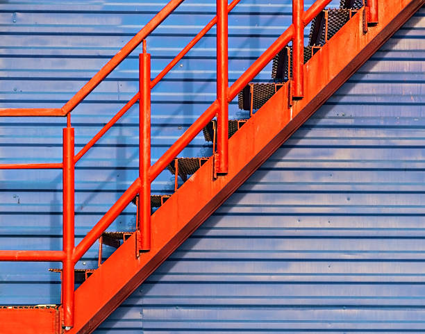 istock part of red fire escape on the blue wall 601146174