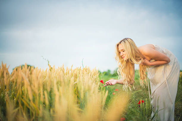 girl hurries among the poppy field