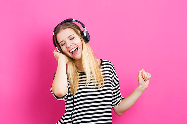 istock Happy young woman with headphone 601151764
