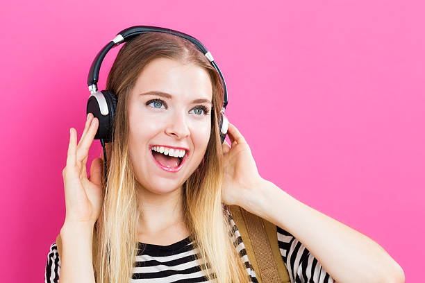 istock Happy young woman with headphone 601151792