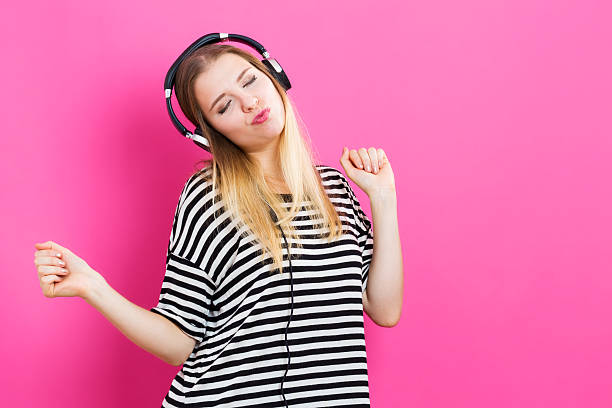 istock Happy young woman with headphone 601151804