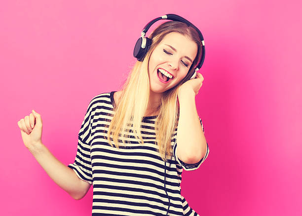 istock Happy young woman with headphone 601151902