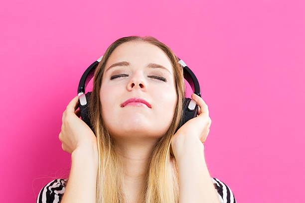 istock Happy young woman with headphone 601151904