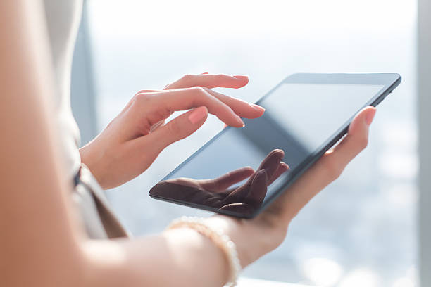 istock Close-up photo of female hands working with tablet computer 601152418