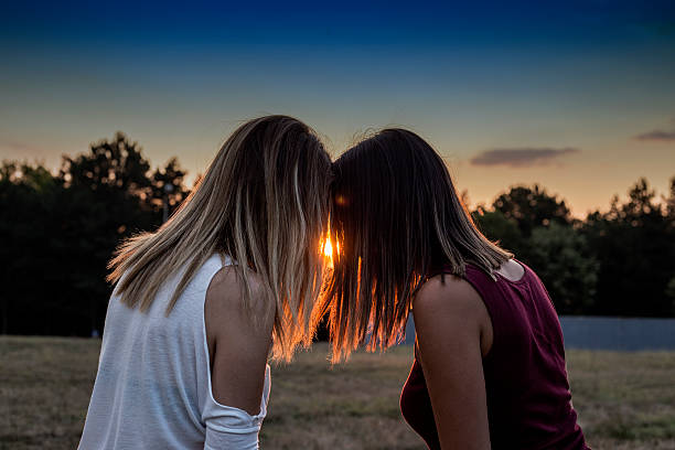 Silent connection between diverse friends. This intimate moment highlights the unspoken bond and multicultural harmony. Lgbtq and gay couple rights concept - Pop Pink filter