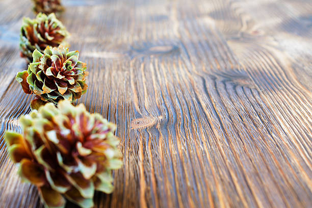 istock Several spruce cones on the wooden background. 601153620