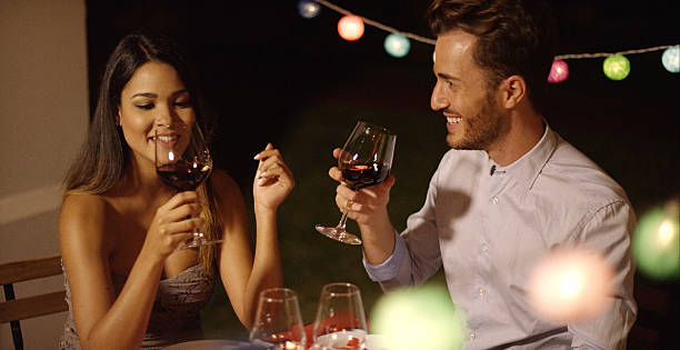 istock Romantic young couple enjoying dinner and wine 601153758