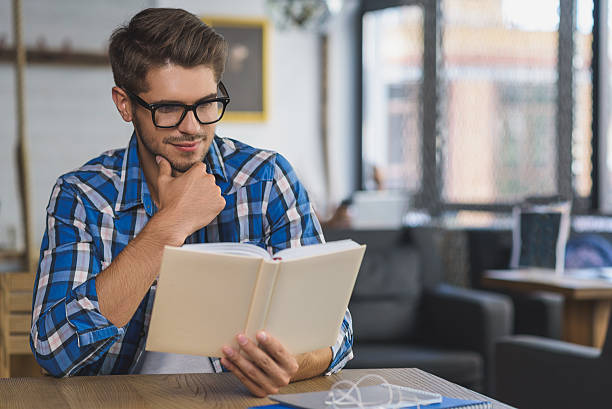 istock young guy enjoying book at home 601153938