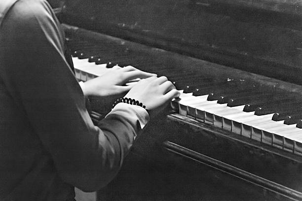 istock female hands on  piano in black and white retro style 601154004