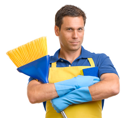 Man in apron with broom and sponge on white