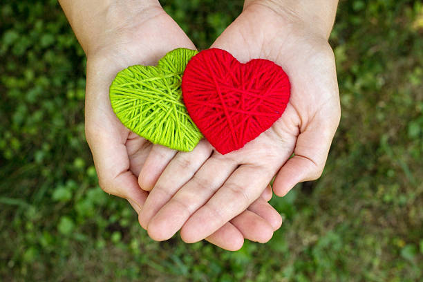 istock red woolen heart in a human hand, valentines day, love 601155086