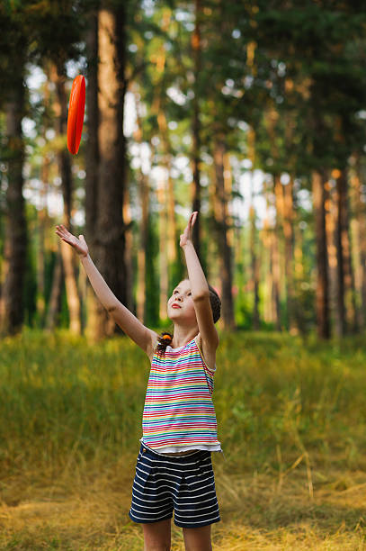 istock girl playing in frisbee 601155318