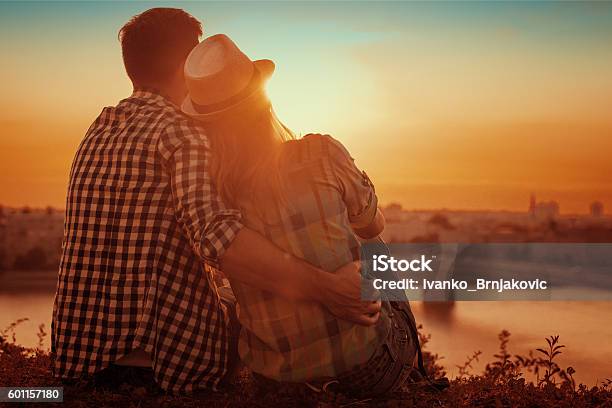 Young Couple Enjoying The Sunset Stock Photo - Download Image Now - Adult, Beach, Beauty