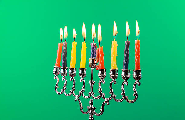 istock Hanukkah menorah with candles green background isolation 601157542
