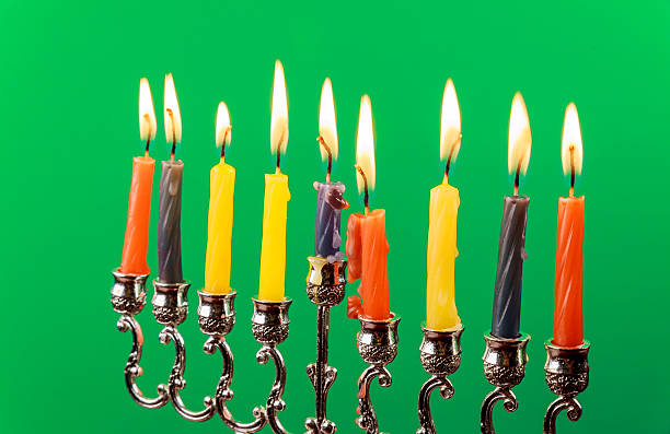 istock Hanukkah menorah with candles green background isolation 601157570