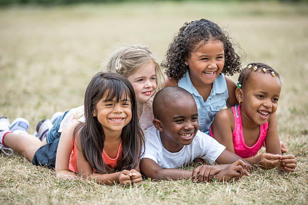 istock Children Lying in the Grass Happily 601157820