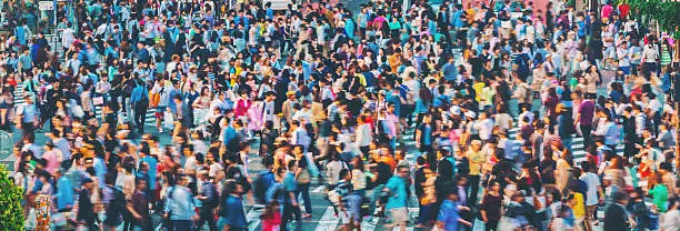 Crowds converge at Shibuya Crossing, one of the busiest crosswalks in the world. Tokyo, Japan