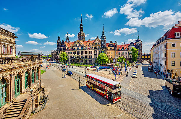 Tourist bus, double-decker bus, sightseeing bus, city tour from the point of view of the Zwinger with a view of the cathedral in Dresden.