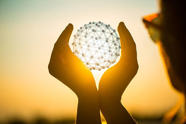young woman at sunset holding sphere network in her hands