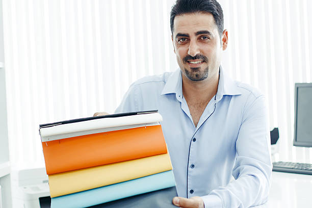 istock Businessman showing artificial leather swatch 601357832