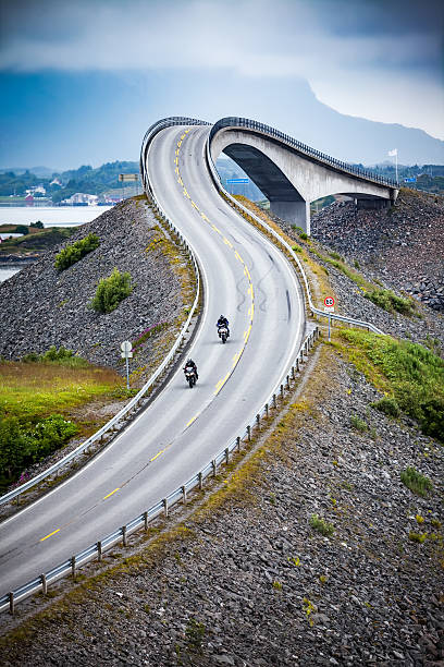 istock Atlantic Ocean Road Two bikers on motorcycles. 601358318