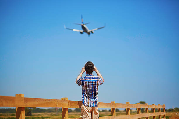 istock Man is looking at the glide path and landing plane 601359508